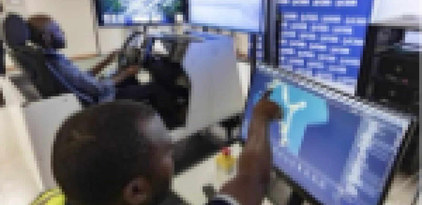 Person pointing at a computer screen